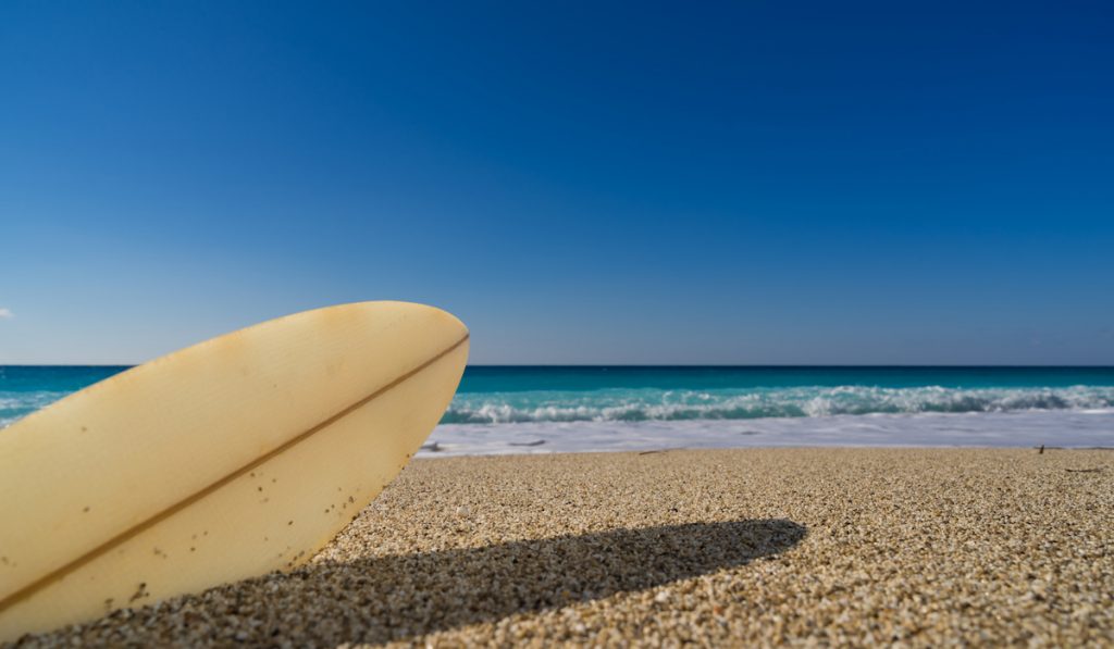 a surfboard under the sun at the beach