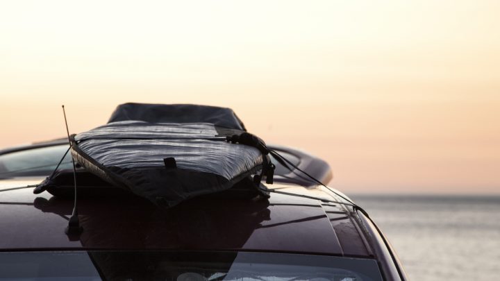 surfboard on the roof of a car