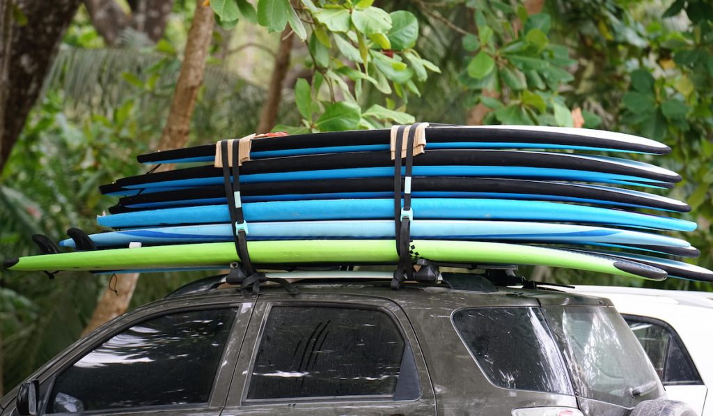 Stack of six surfboards on a car roof rack