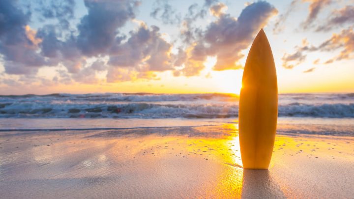 surfboard-on-the-beach-at-sunset