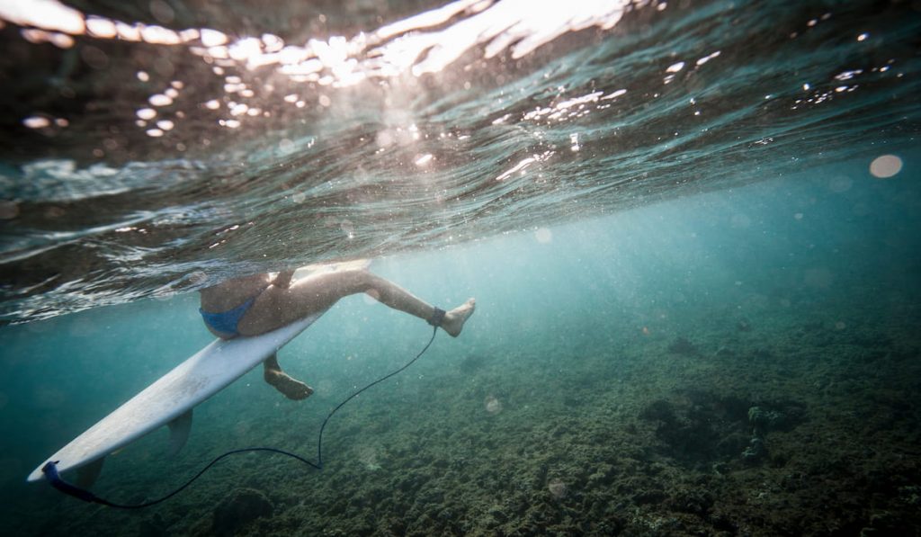 surfer-sitting-on-board-in-water