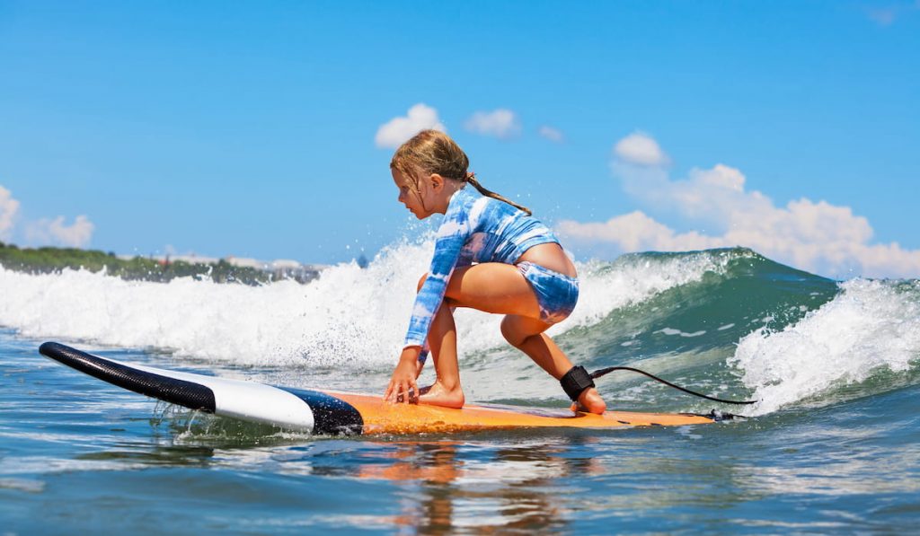 young surfer ride on surfboard with fun on sea waves