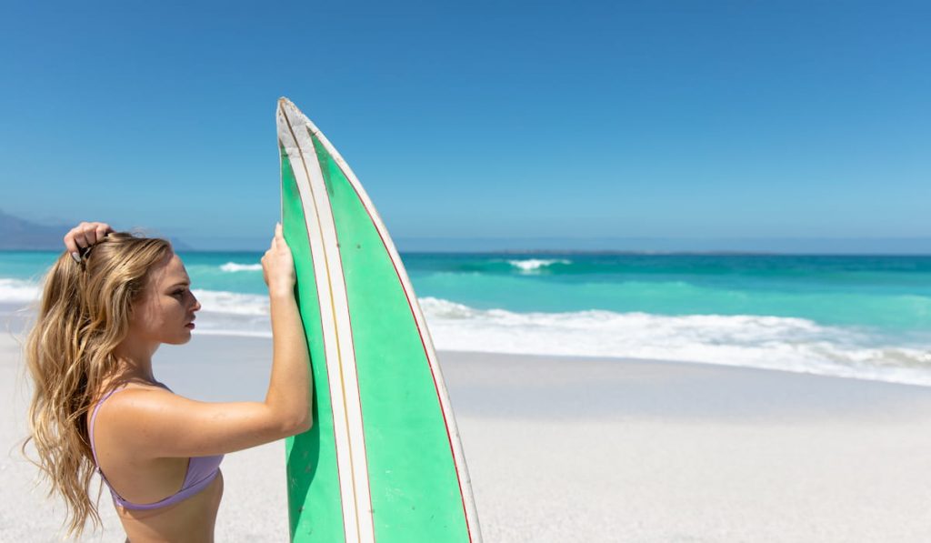 young-woman-with-surfboard-at-the-beach