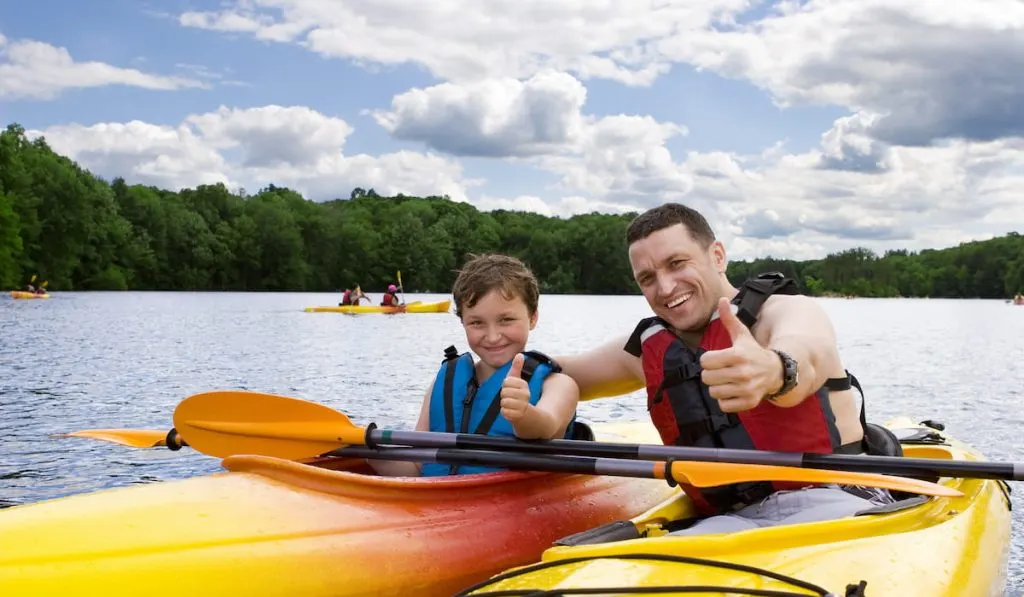father and son enjoys kayaking