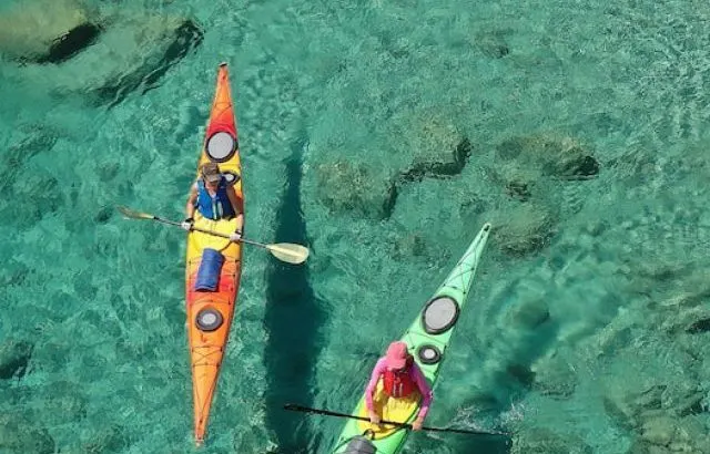 Aerial drone photo of women team of sport kayak paddling in iconic beach in Greece - ss221209