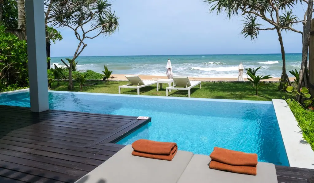 modern house with a swimming pool, modern pool villa at the beach