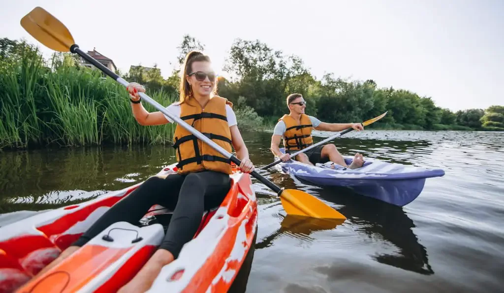 couple together kayaking on the river 