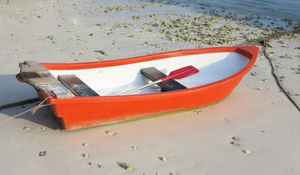 small orange boat fiberglass on beach