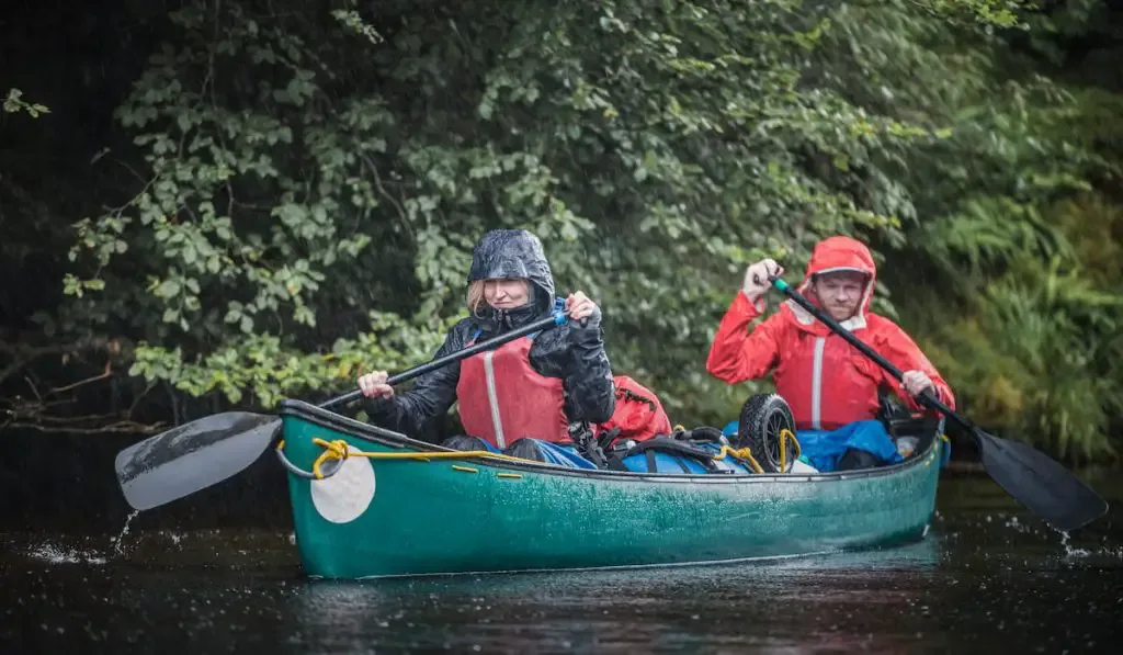 a couple in a canoe during a bad weather