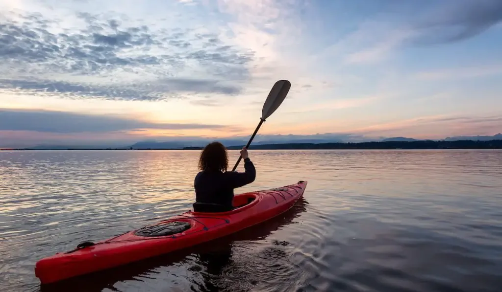 kayaking during a colorful sunset