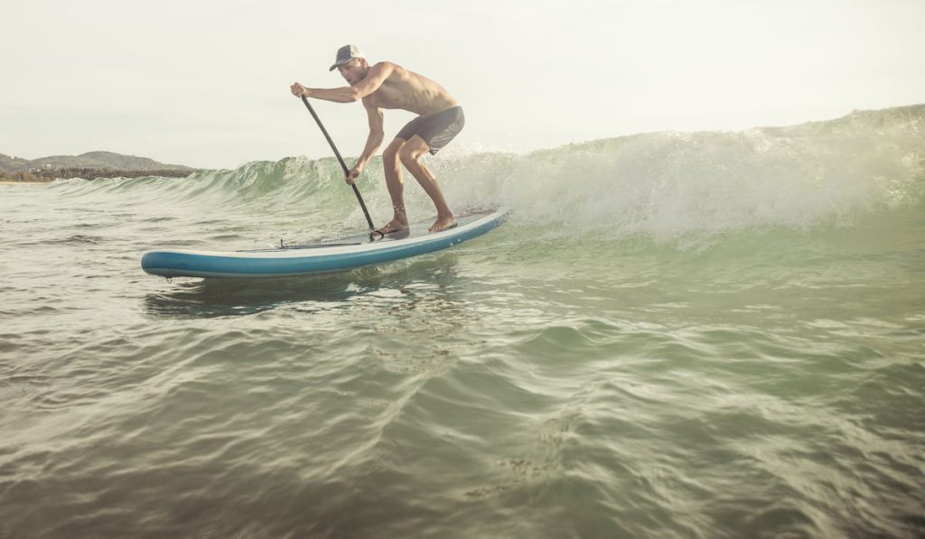 surfer with paddleboard on the waves